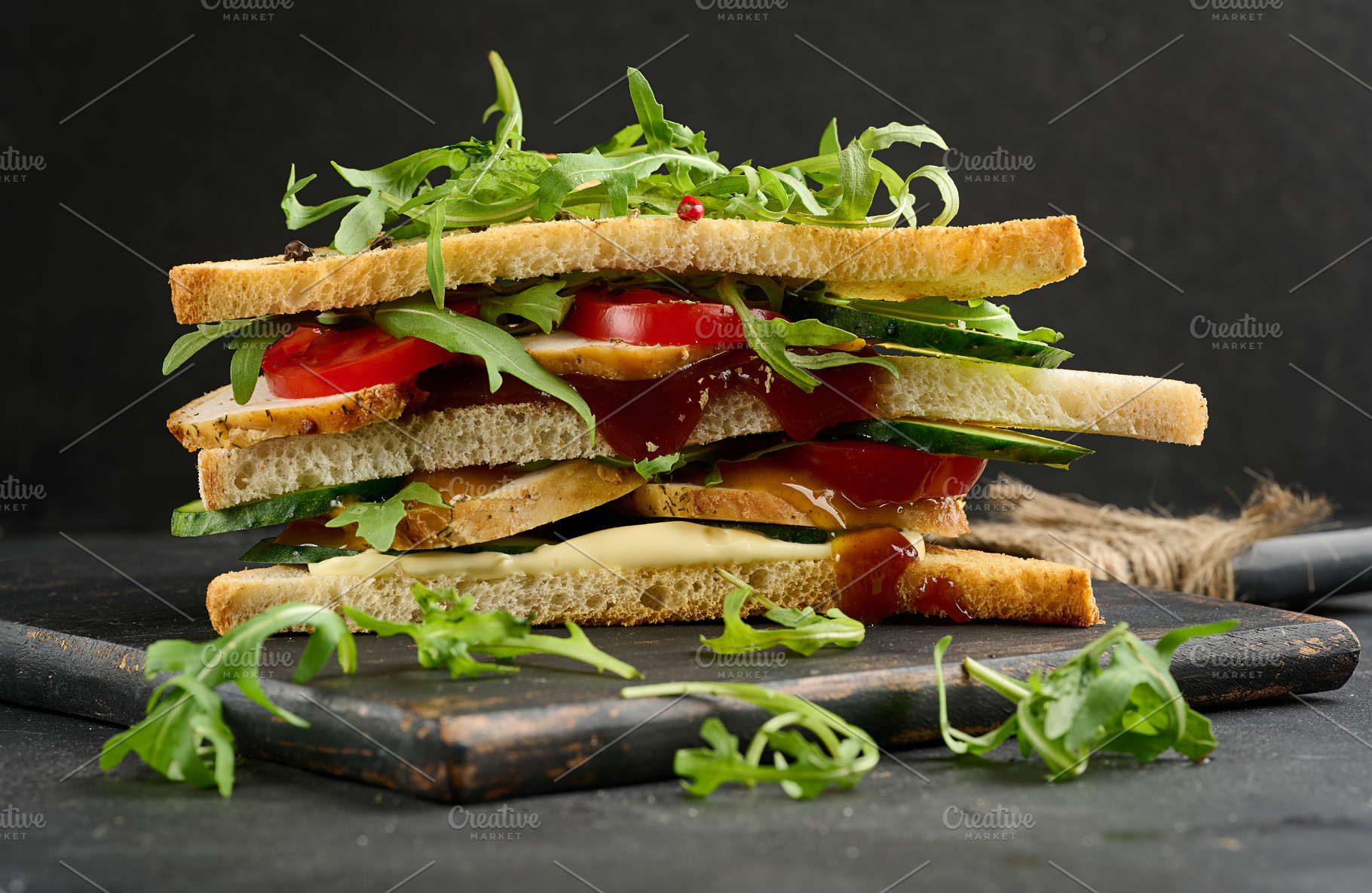 Grilled chicken sandwich with fresh tomatoes, cucumbers, arugula, a Food & Drink Photo by ndanko