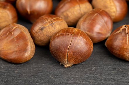 a cross incised on a chestnut shell edible Asian chestnut fruits for frying or, a Photo by MyPhotos