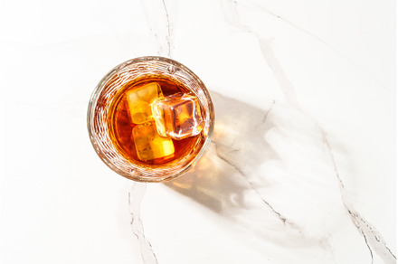 Whiskey with ice cube in the glass