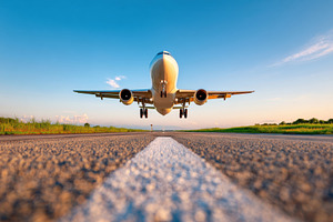 Airplane taking off from runway under blue sky, a Transportation Photo by AlyaAnd