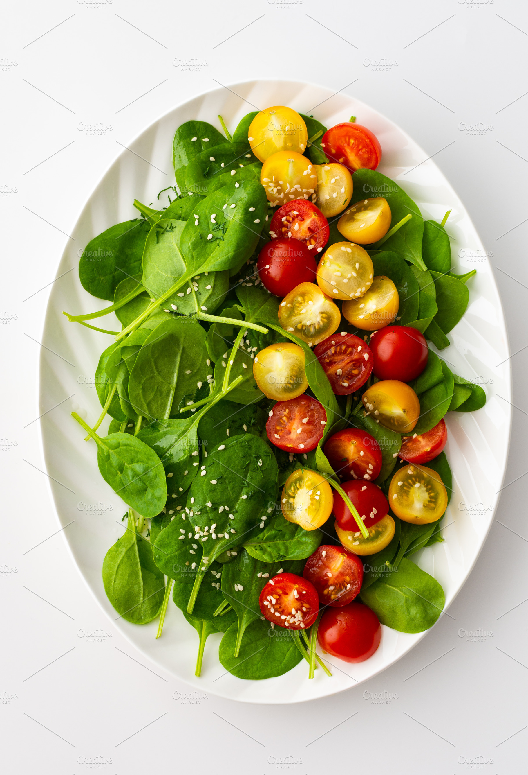 Salad with tomatoes and spinach, a Food & Drink Photo by Pandateam