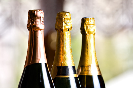 Bottles of champagne on a table. High quality photo., a Food & Drink Photo by FoodStock
