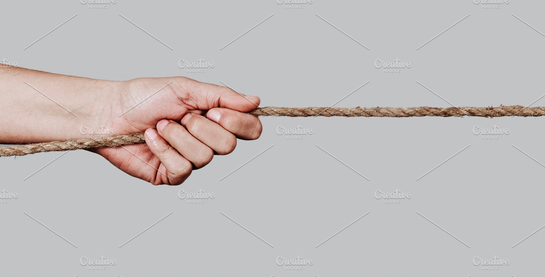 man pulling a rope, web banner format, a Photo by Nito