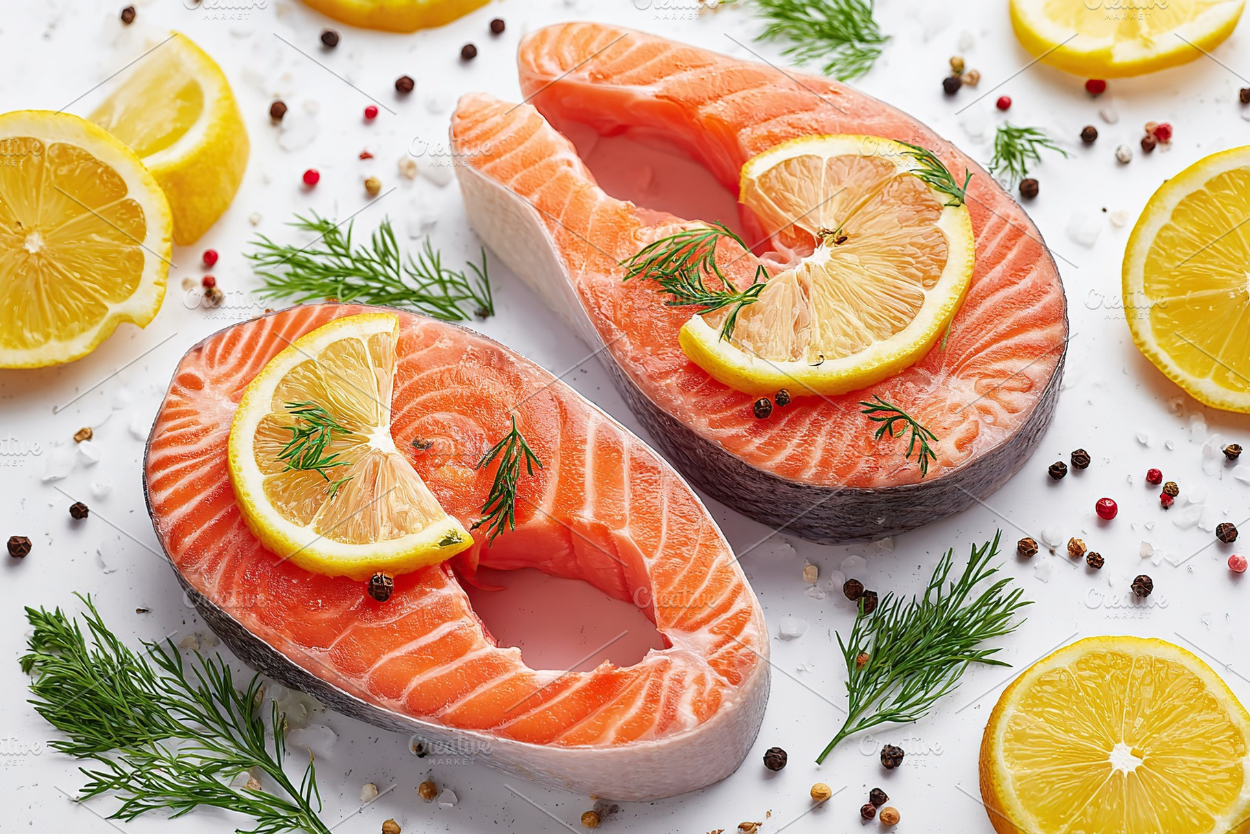 Fresh raw salmon steaks garnished with lemon slices and herbs on a clean white, a Food & Drink Photo by AlyaAnd