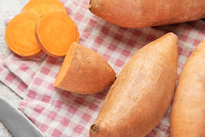 Sweet potato preparation with ingredients for healthy cooking, a Food & Drink Photo by Olena Rudo