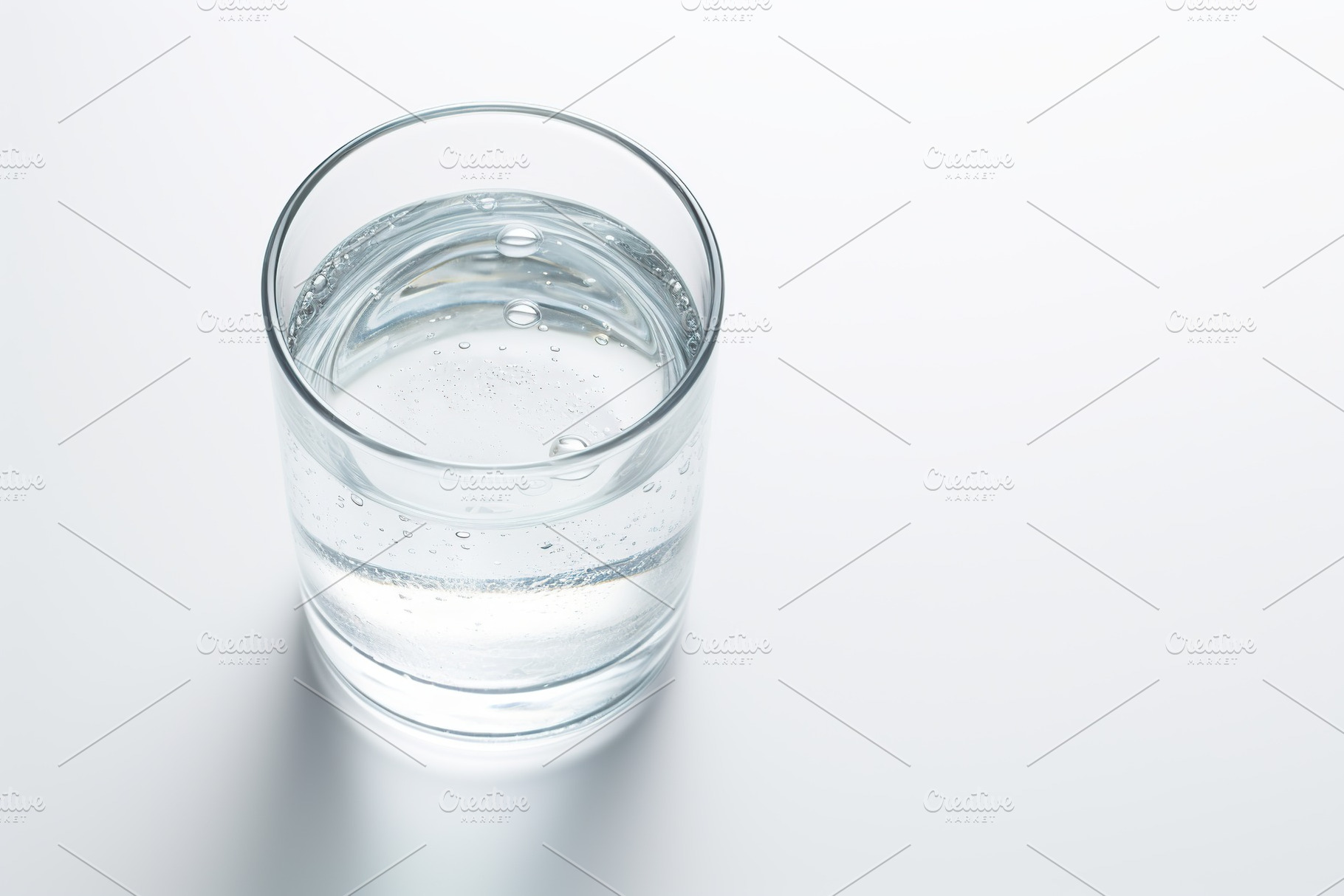 Glass of water isolated on white background, a Food & Drink Photo by AlyaAnd