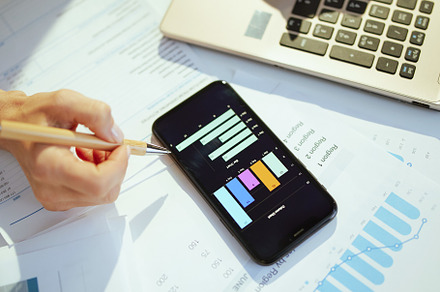 Business owner woman using phone, working with documents, a Business Photo by Alliance Images