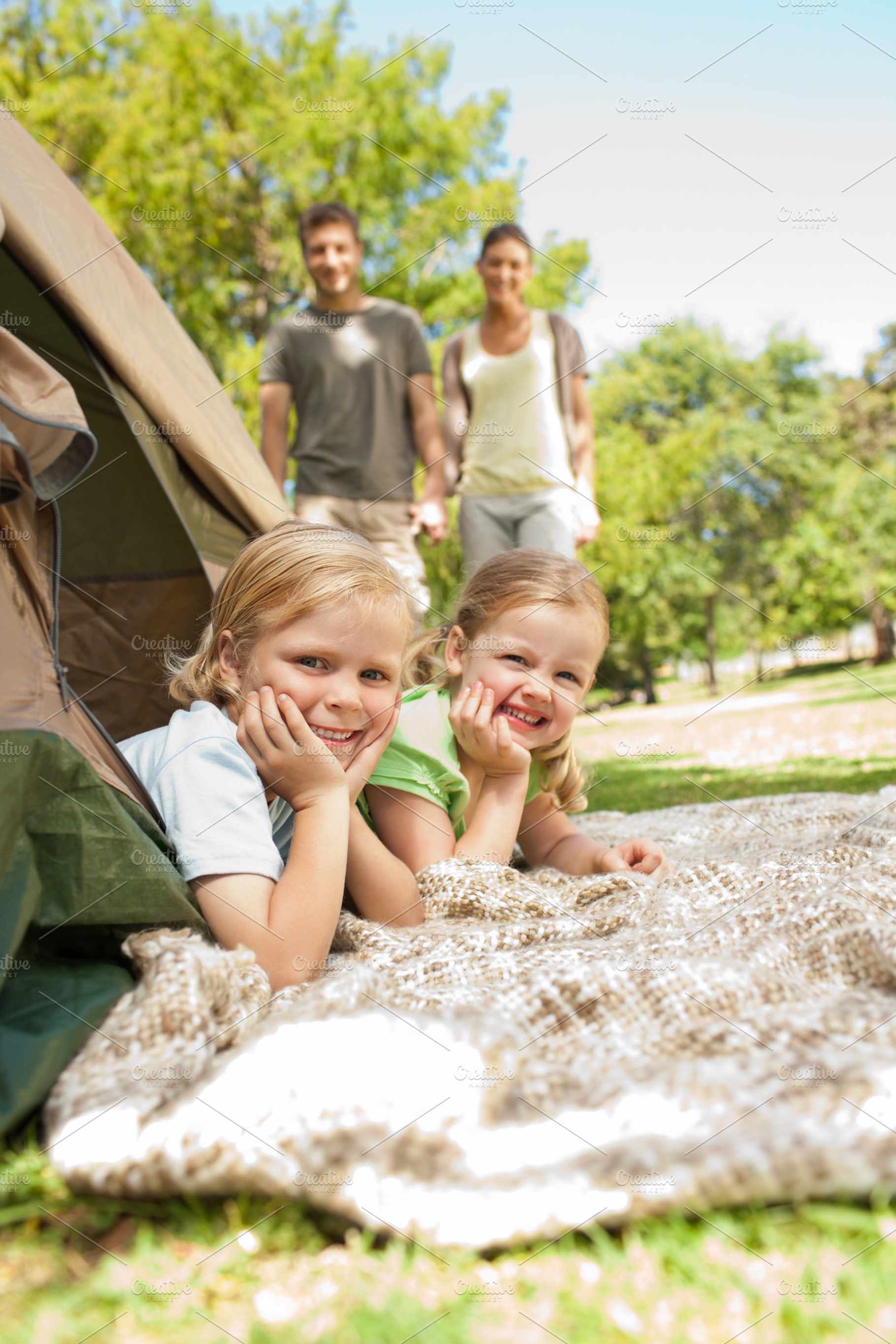 Happy family camping in the park, a Photo by wavebreak