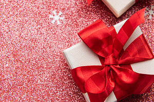 Christmas gifts decorating a red glitter background, a Holiday Photo by Olena Rudo