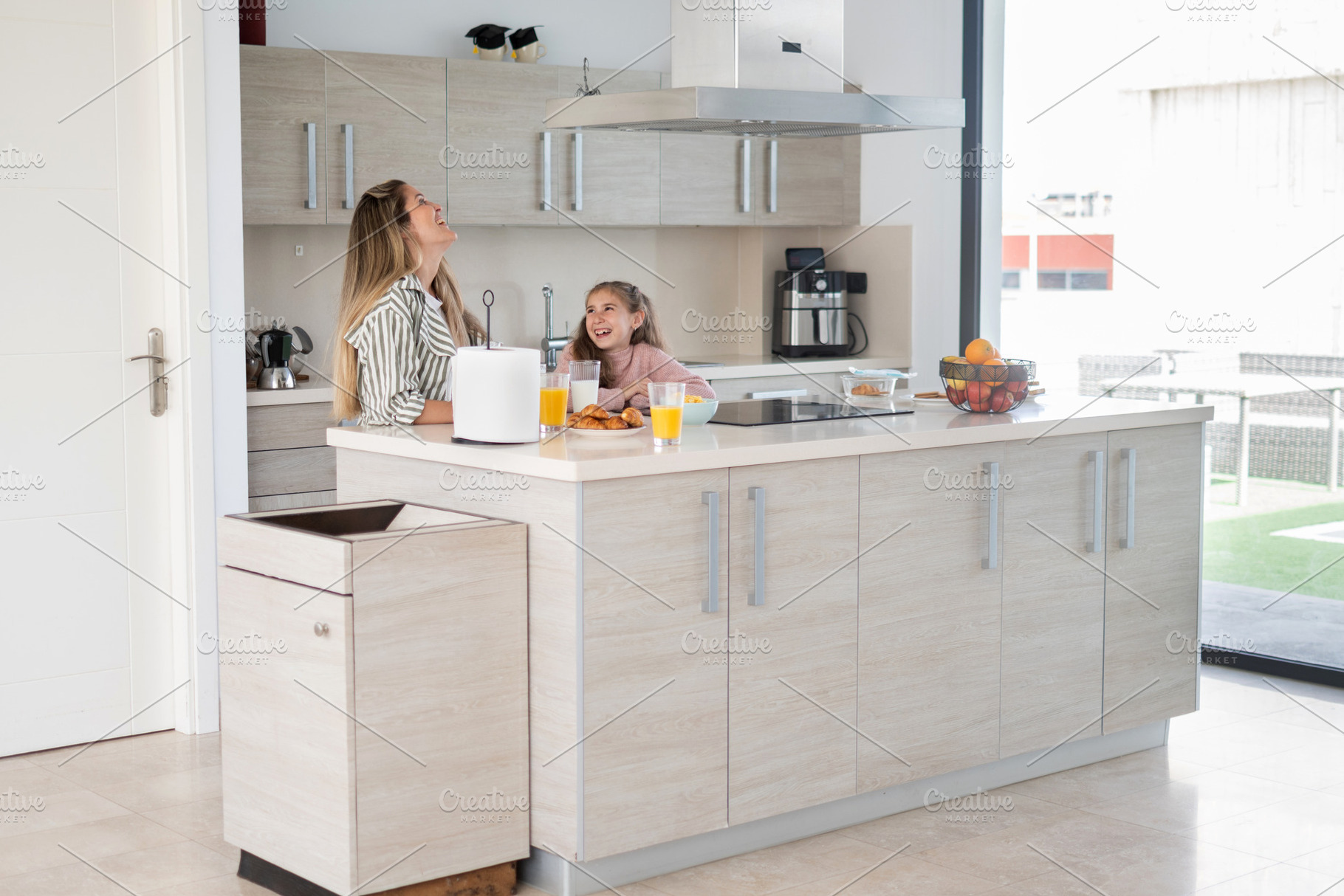 Mother and daughter enjoying breakfast together in modern kitchen at home, a Person Photo by etorres69