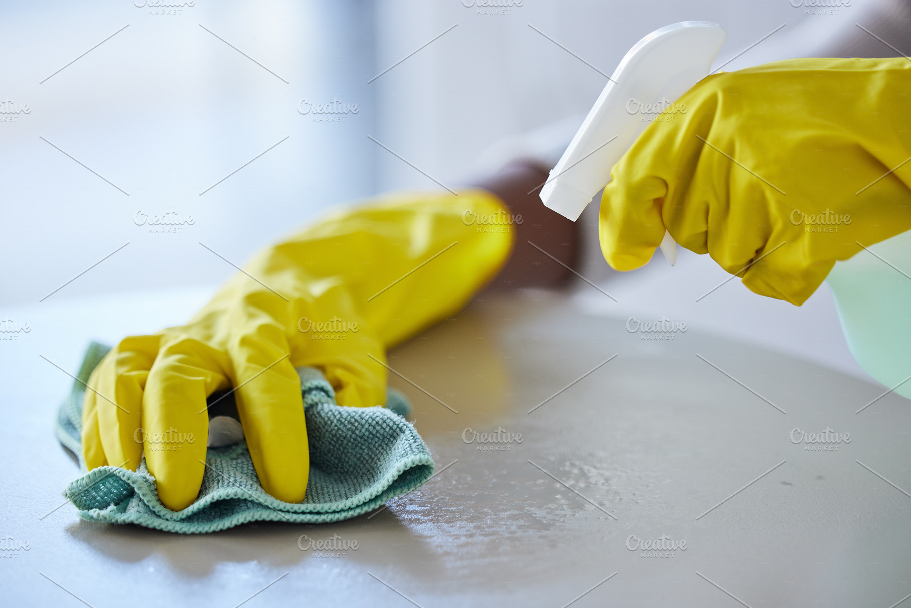 Cleaning, housekeeping and hands with cloth and spray bottle to wipe, disinfect and clean furniture. Housework, spring cleaning and rubber gloves with detergents, cleaning products and chemical spray, a Photo by Peopleimages.com