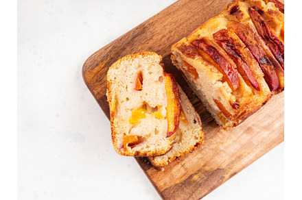 Peach cake loaf on wooden cutting