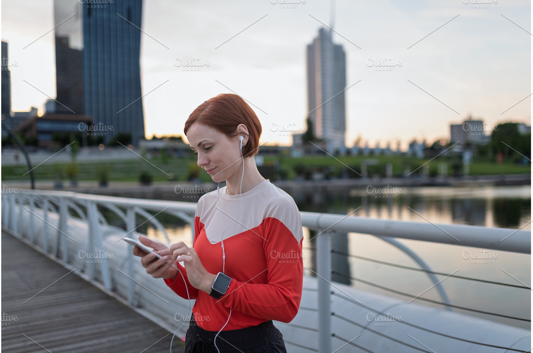 Runner checking her performance on a, a Sports & Recreation Photo by HalfPoint
