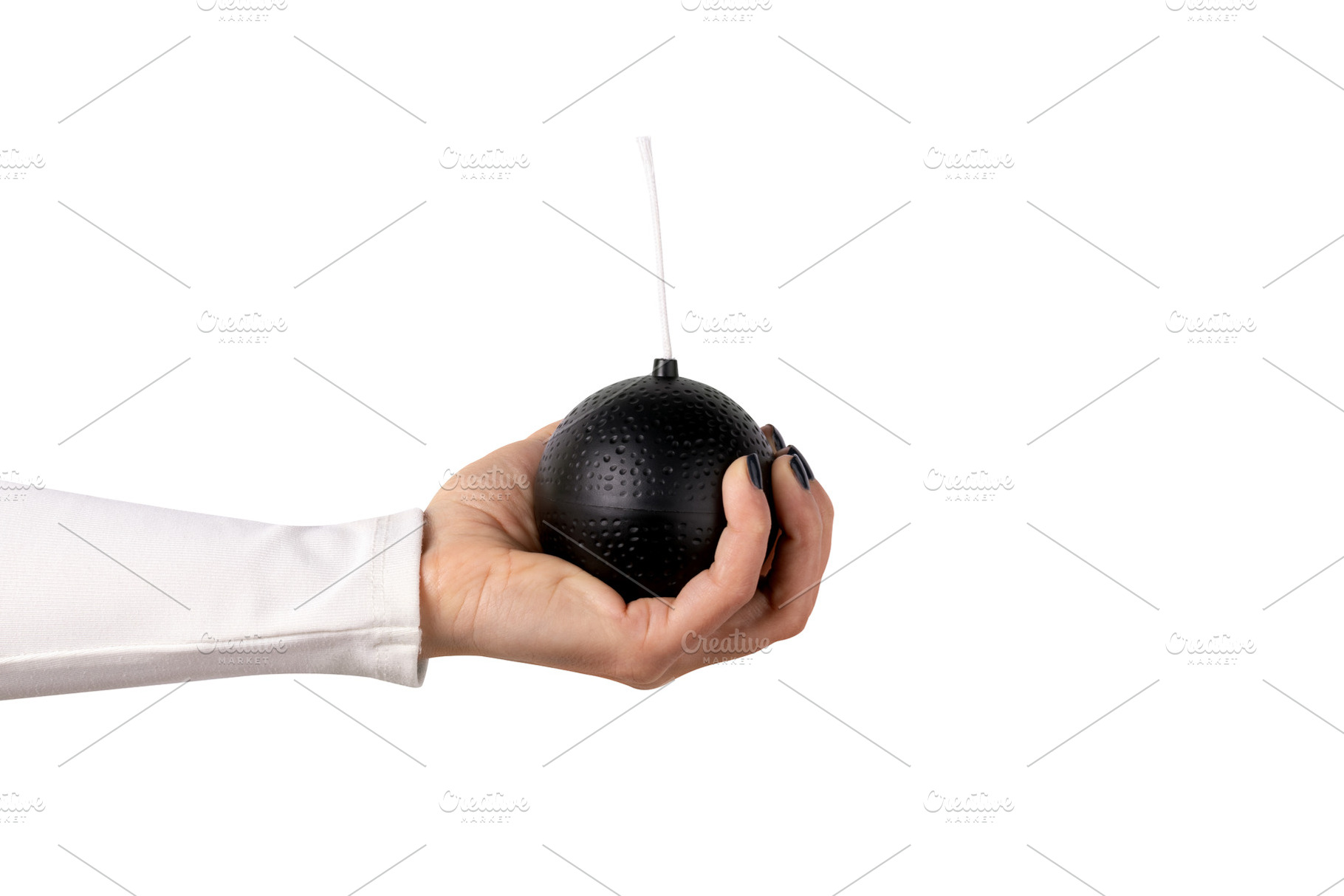 A person’s hand holds a round black bomb prop with a white fus, a Technology Photo by Ales Munt