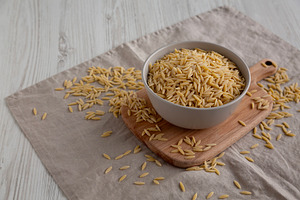 Organic Dried Orzo Pasta in a Bowl, side view. Copy space., a Food & Drink Photo by LiudmylaChuhunova