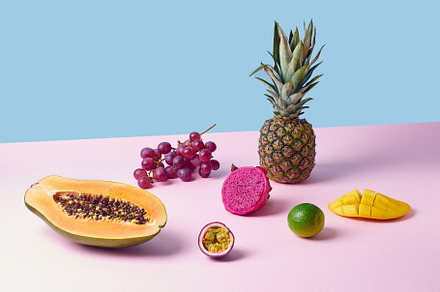 Tropical fruits variety on a colorful background. Side view with