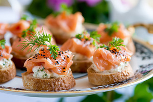 Smoked salmon canapes with cream cheese and dill, garnished with black sesame s, a Photo by Studio ANNA