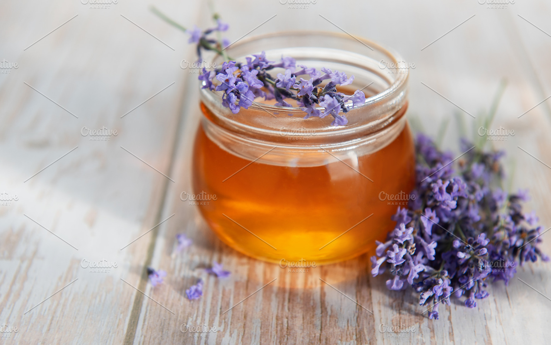 Lavender honey jar with fresh flowers on wood, a Food & Drink Photo by Olena Rudo