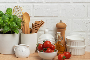 Kitchen utensils, fresh tomatoes and basil creating a modern cul, a Food & Drink Photo by Olena Rudo