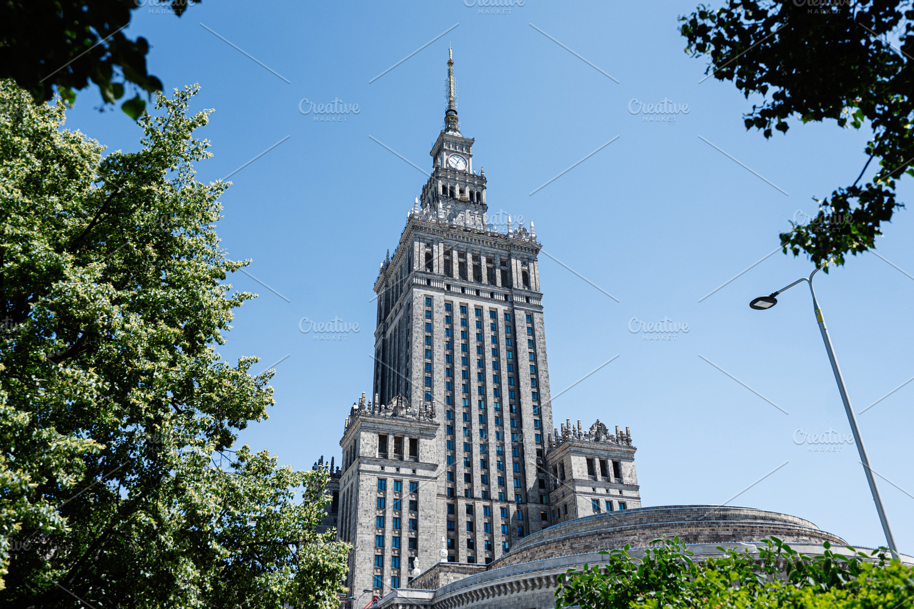Historic building Congress Hall surrounded by trees and blue sky in a serene ur, a Photo by AS photostudio