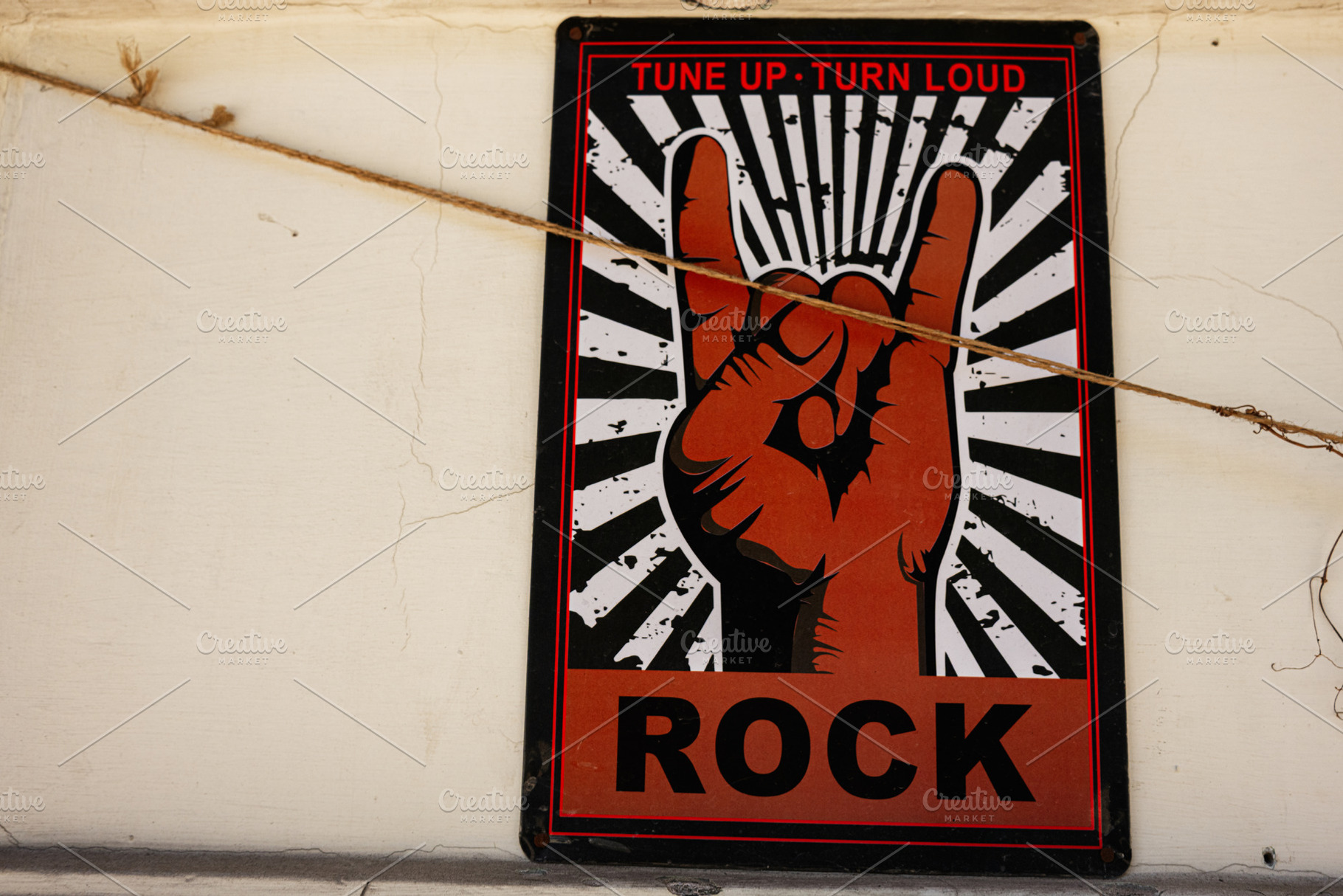 Rock music hand gesture art sign on a textured urban wall, a Photo by AS photostudio