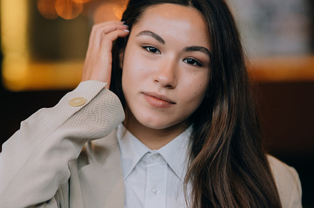 Headshot portrait of smiling young woman. Close up.