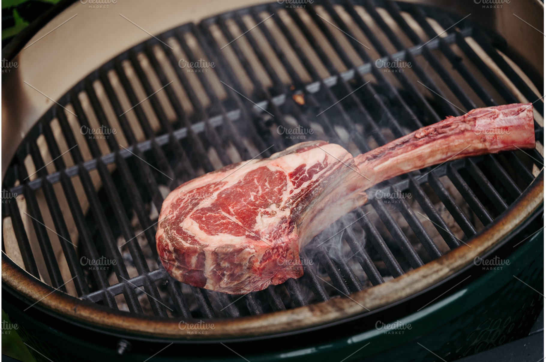 Grilling juicy Tomahawk steak on, a Food & Drink Photo by HalfPoint