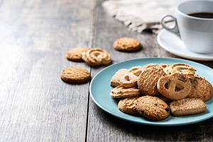 Assorted butter cookies on plate with cup of coffee, a Food & Drink Photo by etorres69