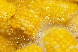 Fresh sweet corn cobs boiling in water, a Food & Drink Photo by Olena Rudo