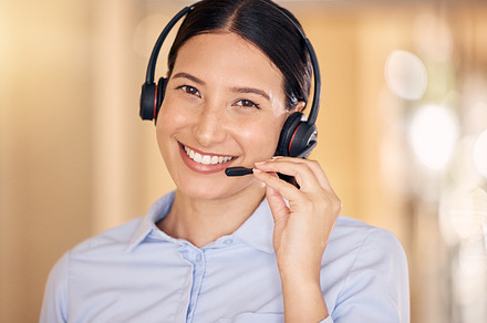 Call center agent, employee and worker with smile and headphone working at telemarketing company and helping people online at work. Portrait of face of happy customer service worker consulting, a Photo by Peopleimages.com