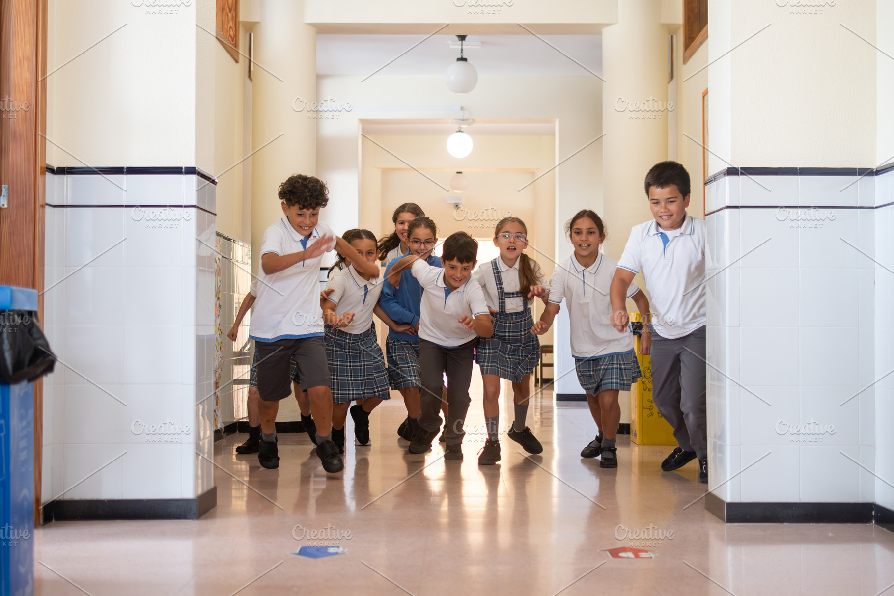 Happy elementary school children running through a school hallway, a School & Education Photo by etorres69