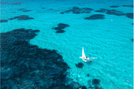 Aerial view of sailboat on blue sea, a Nature Photo by den-belitsky