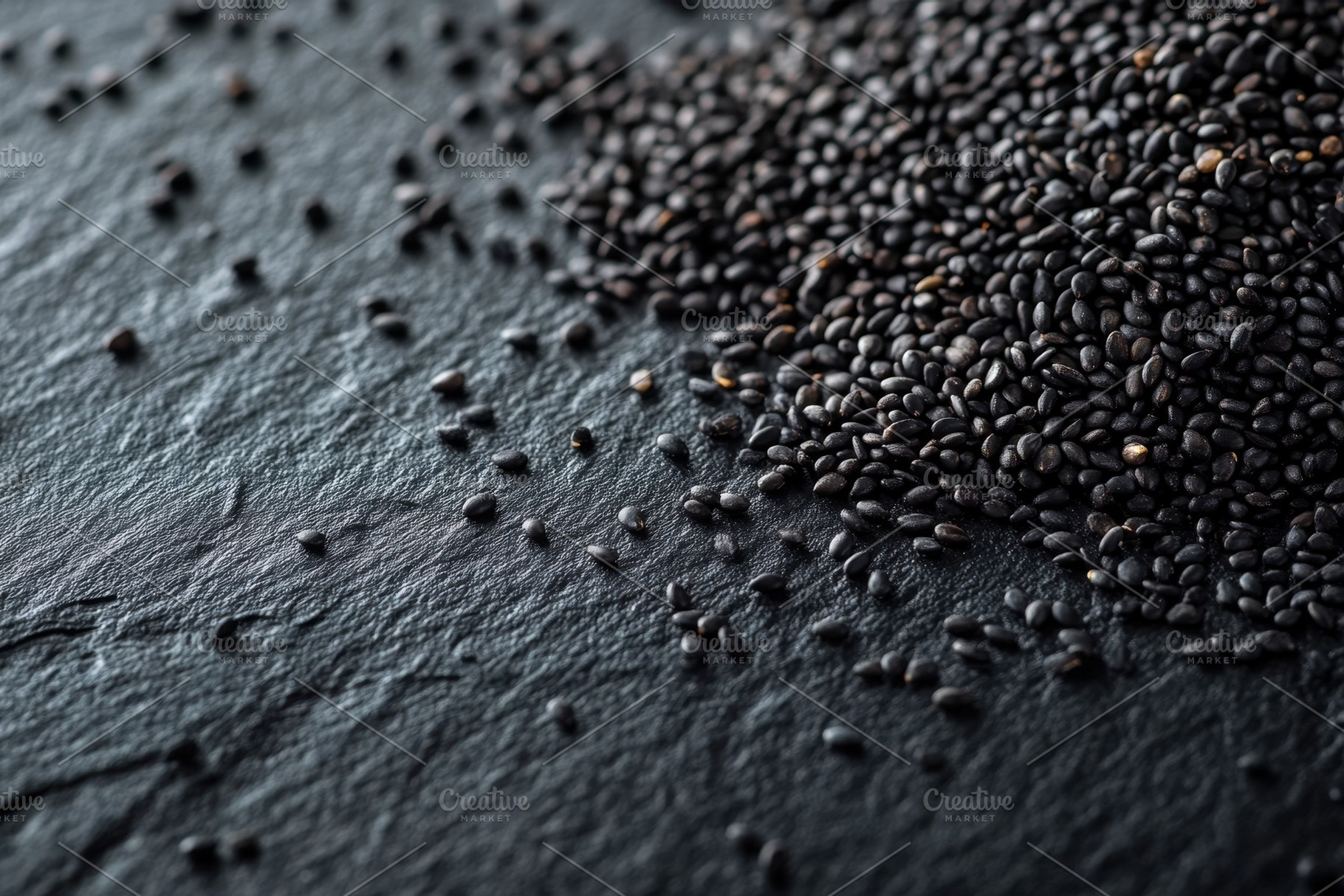 Scattered black sesame seeds on a da, a Photo by Iftikhar Alam