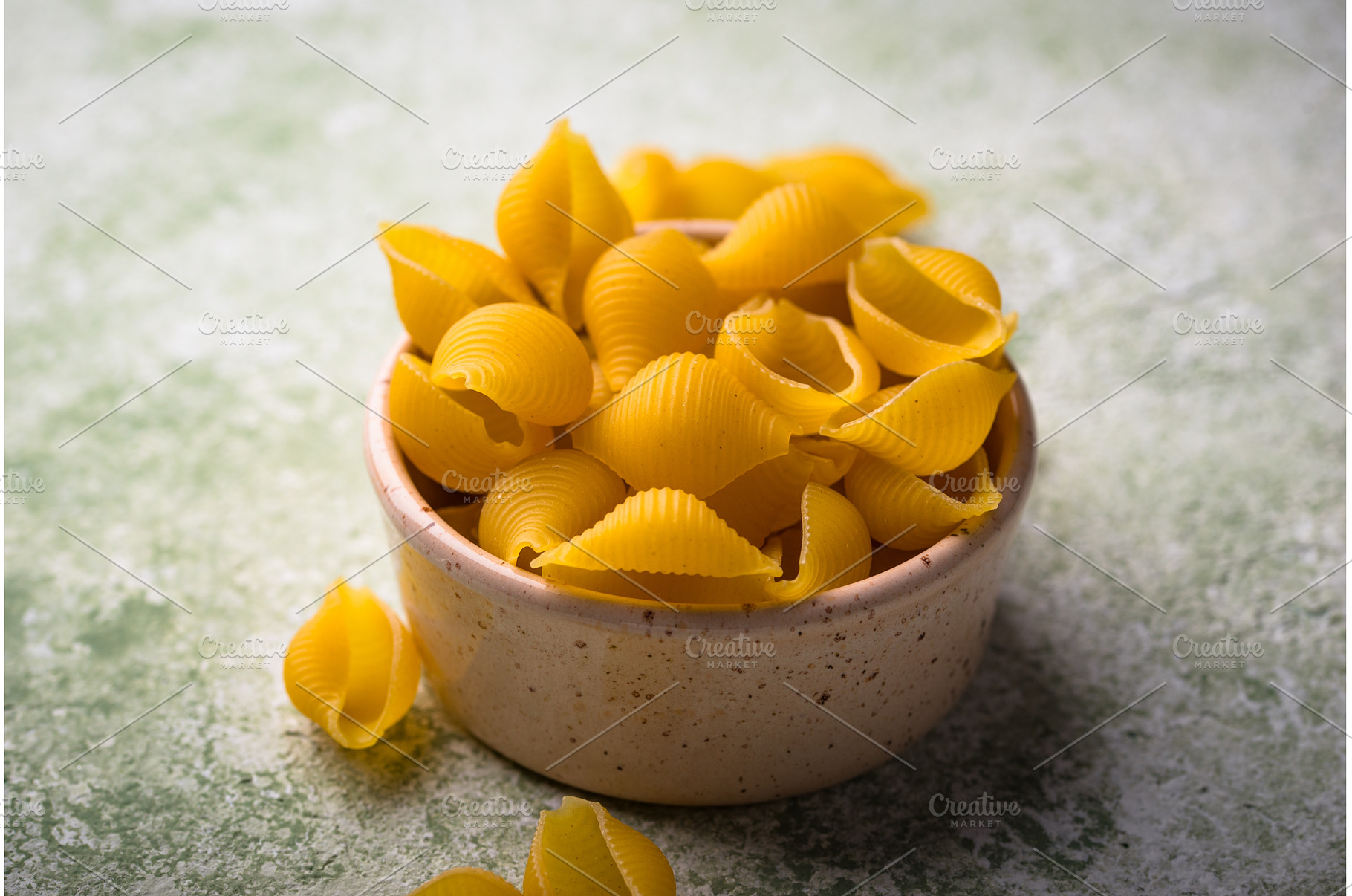 Raw pasta in shape of shells, a Food & Drink Photo by Yulia Furman