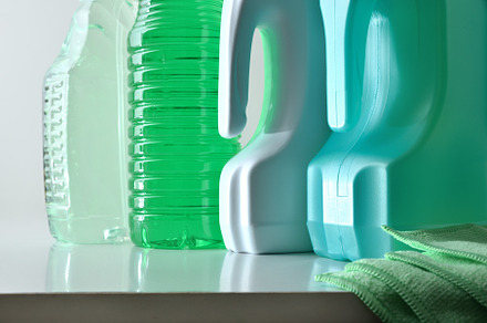 Four plastic bottles with disinfectant products on a white bench, a Health & Medical Photo by Davizro's Market