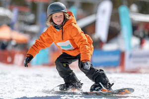 Young boy snowboarding in winter, a Sports & Recreation Photo by AlyaAnd