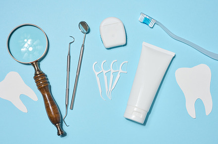 Set of oral hygiene products and tools, tube of toothpaste, dent