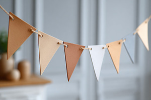 Delicate arrangement of minimalist paper bunting flags hanging indoors in a mod, a Background Photo by AlyaAnd