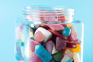Hand taking candy from glass jar, a Food & Drink Photo by etorres69