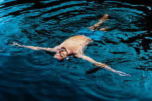 Man floating calmly in blue water, a Person Photo by Perpis