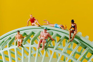five miniature people in swimwear on a green fan, a Photo by Nito