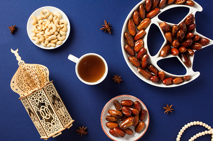 Ramadan Kareem composition. Dried dates in Islamic star and crescent bowl, wood, a Holiday Photo by photoguns