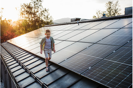 Boy walking on roof with solar
