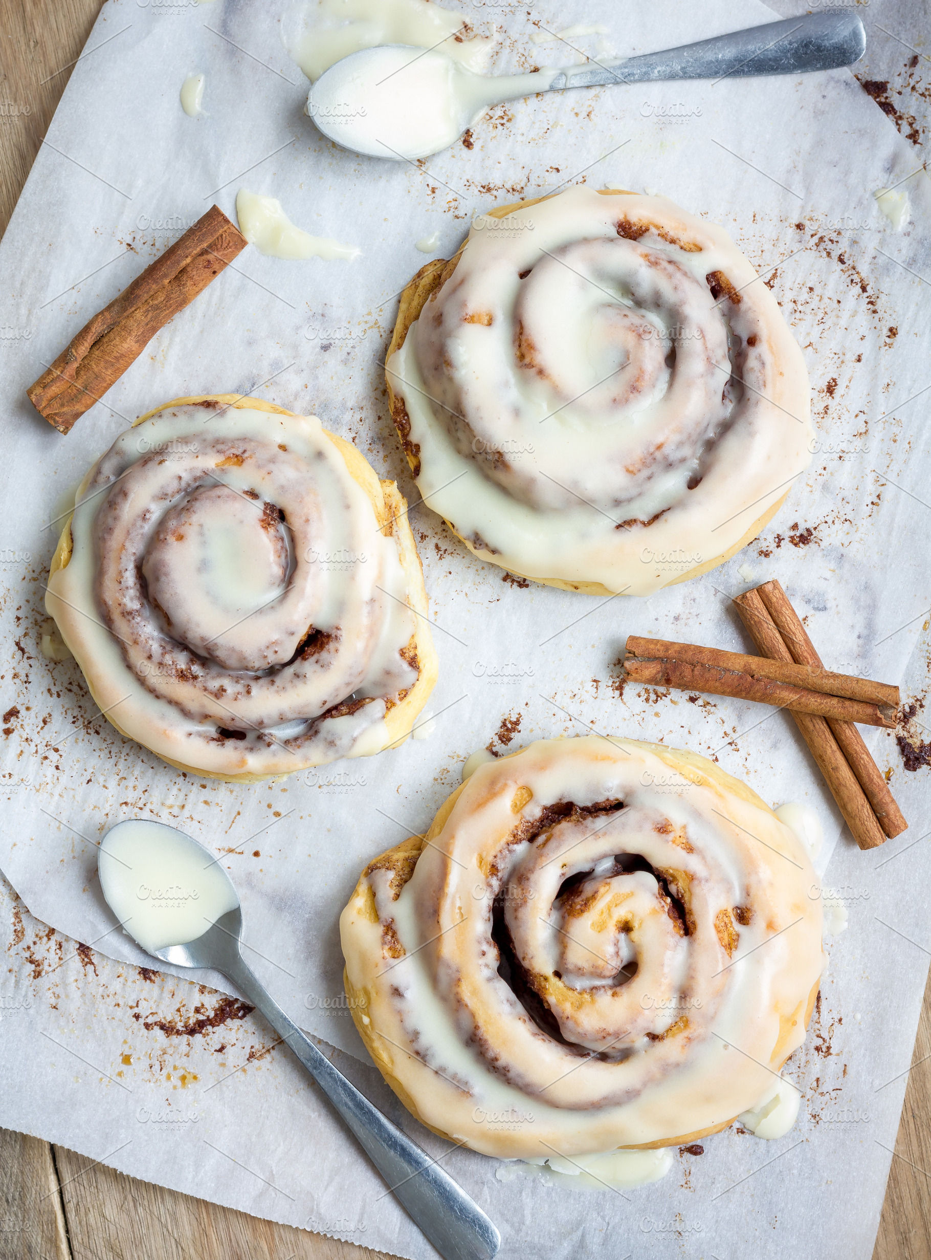 Homemade cinnabons cinnamon rolls wi containing dessert, cream, and food, a Food & Drink Photo by iuliia_n