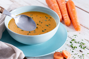 Creamy Carrot Soup in Blue Bowl on White Wooden Table, a Food & Drink Photo by etorres69