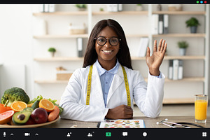 Friendly black dietitian giving online consultations, sitting at workplace and, a Person Photo by Prostock-Studio