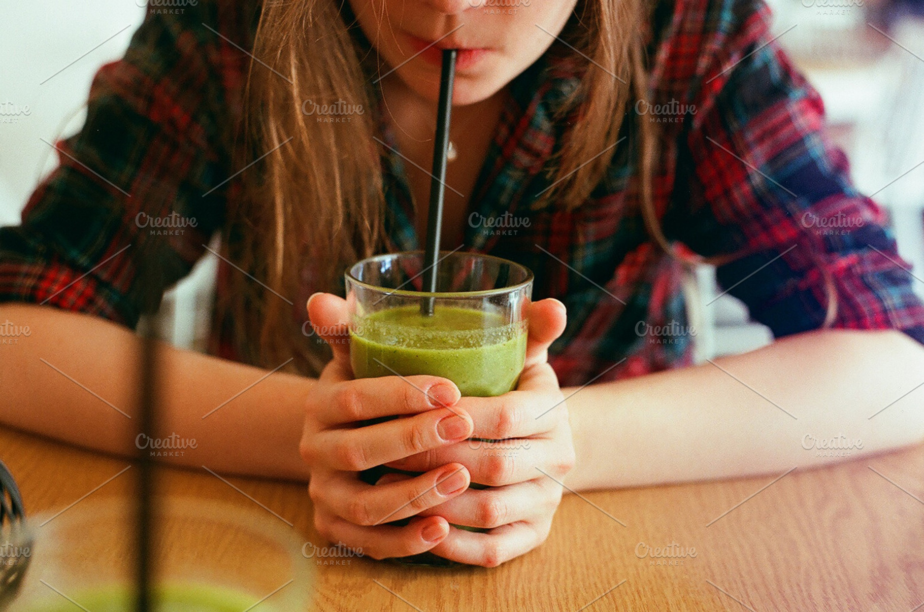 Girl drinking a green smoothie stock, a Food & Drink Photo by Kasia Górska