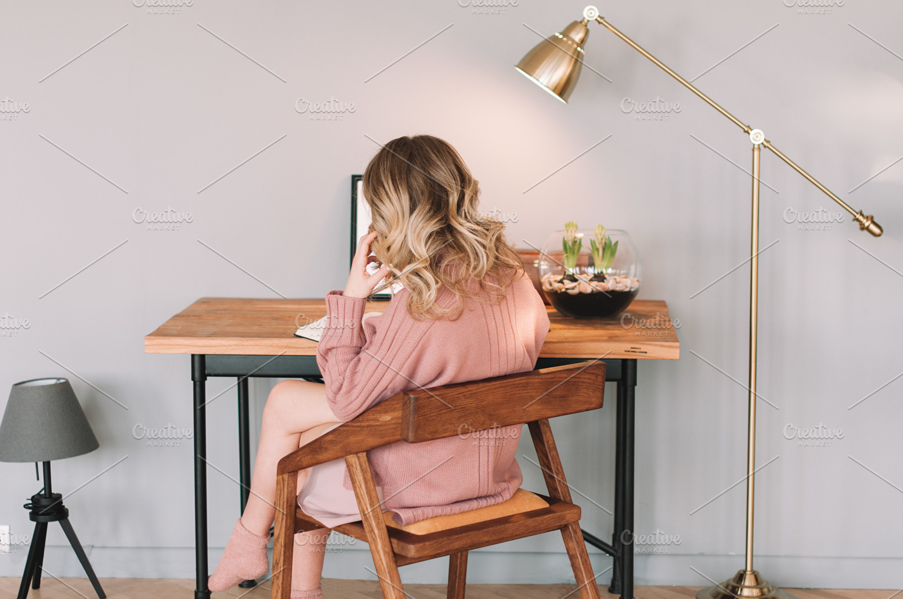 Young woman at the table, a Person Photo by kostanashvili