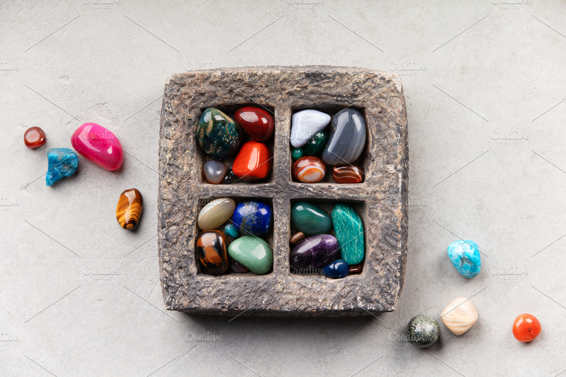 Colorful Tumbled Gemstones in Rustic Stone Tray on Light Surface, a Nature Photo by Natalia Klenova's Shop
