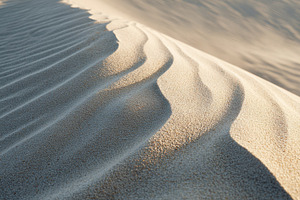 Soft shadows on sand dunes in desert landscape, a Wallpaper Photo by AlyaAnd